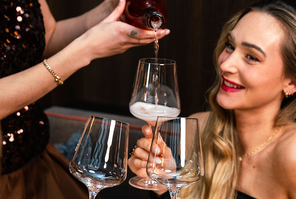 Ein Kellner schenkt einer Dame ein Glas Wein ein | © Cavalli