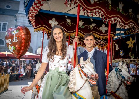 Magdalena Gassner und Sebastian Aigner am nostalgischen Pferdekarussell am Residenzplatz | © Andreas Kolarik